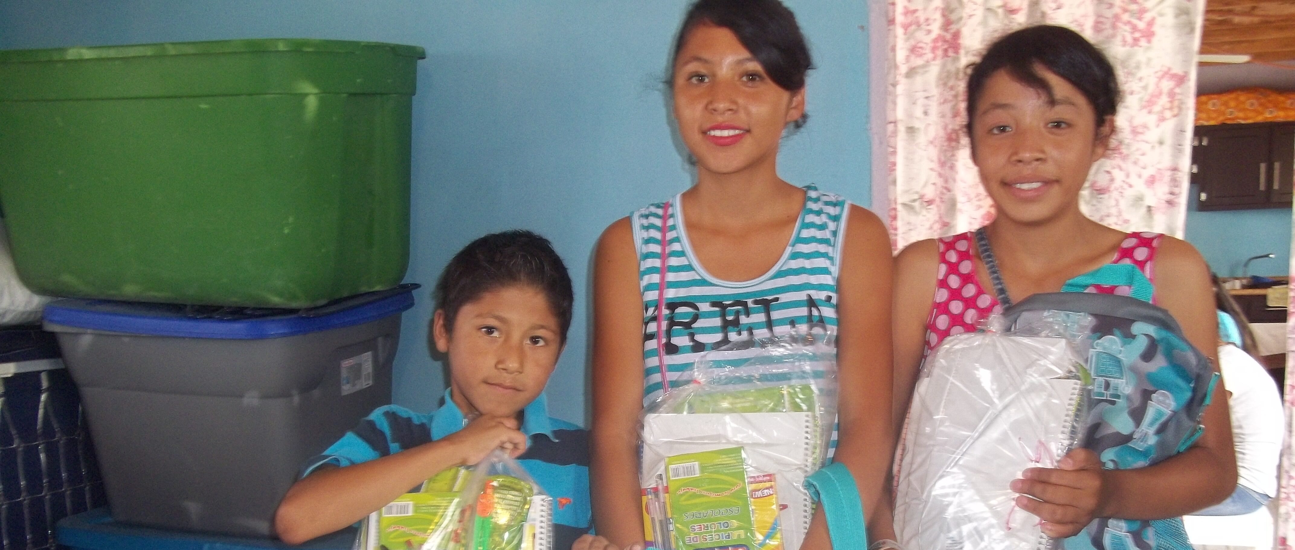 youth receiving backpacks full of school supplies