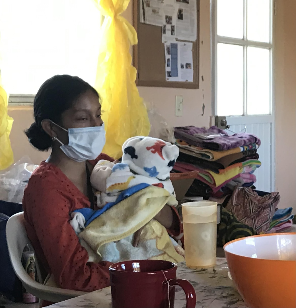 a new mother holding a baby wrapped in a blanket