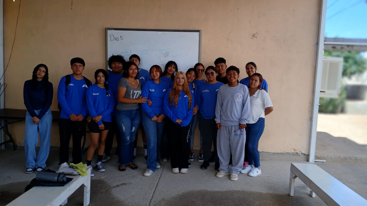 group of kid standing against a wall